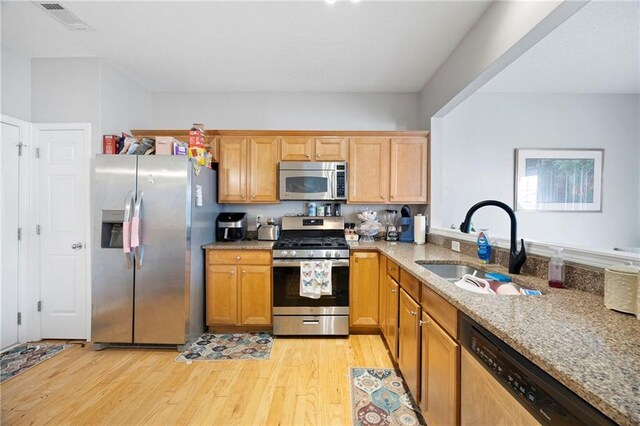 212 Regent Sq, Woodstock, GA 30188 - kitchen featuring visible vents, light stone countertops, a sink, light wood finished floors, and stainless steel appliances