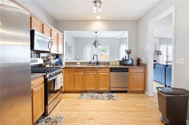 212 Regent Sq, Woodstock, GA 30188 - kitchen featuring a sink, light wood-style floors, stainless steel appliances, and a wealth of natural light