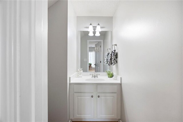212 Regent Sq, Woodstock, GA 30188 - bathroom featuring a textured ceiling, an inviting chandelier, and vanity