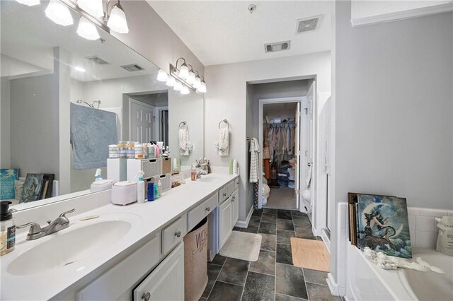 212 Regent Sq, Woodstock, GA 30188 - full bathroom with visible vents, double vanity, a bath, a sink, and stone finish flooring