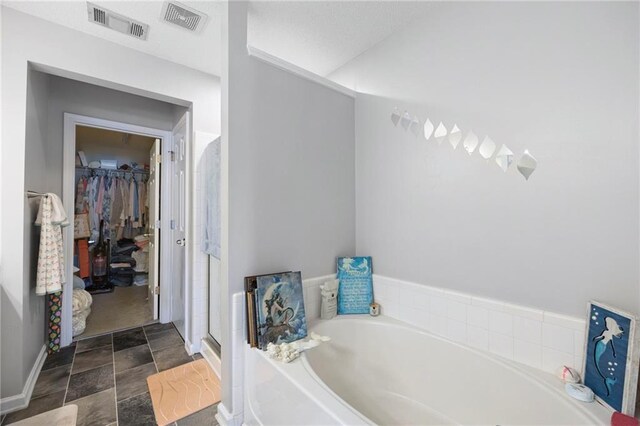 212 Regent Sq, Woodstock, GA 30188 - full bath with a bath, stone finish floor, a spacious closet, and visible vents