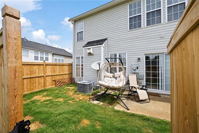 212 Regent Sq, Woodstock, GA 30188 - back of house featuring a lawn, fence, and central AC unit