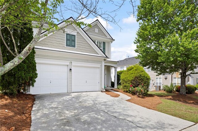 212 Regent Sq, Woodstock, GA 30188 - view of front of property with concrete driveway, an attached garage, and central AC