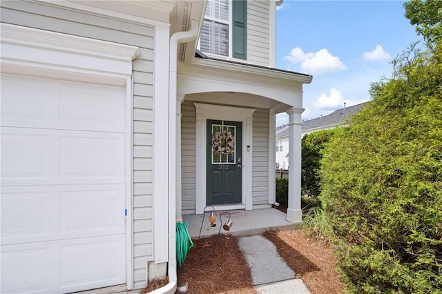 212 Regent Sq, Woodstock, GA 30188 - doorway to property with covered porch and an attached garage