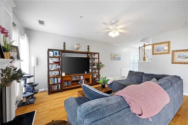 212 Regent Sq, Woodstock, GA 30188 - living area featuring baseboards, ceiling fan, visible vents, and light wood-style flooring