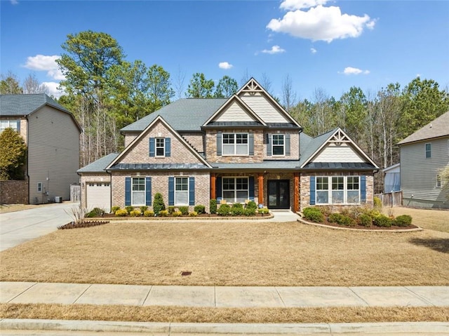 craftsman inspired home with brick siding, concrete driveway, and a garage