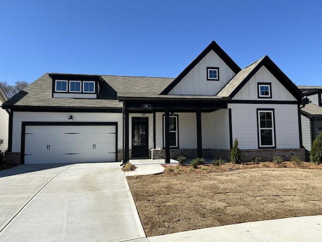 view of front of property featuring a garage, covered porch, board and batten siding, and concrete driveway