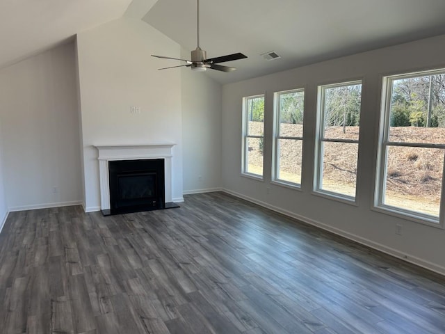 unfurnished living room featuring dark wood-type flooring, a fireplace, visible vents, and lofted ceiling