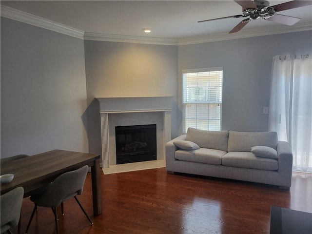 living room with crown molding, dark wood-type flooring, and ceiling fan