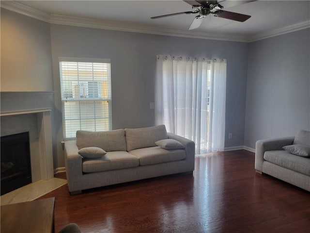 living room featuring dark wood-type flooring, ceiling fan, and crown molding