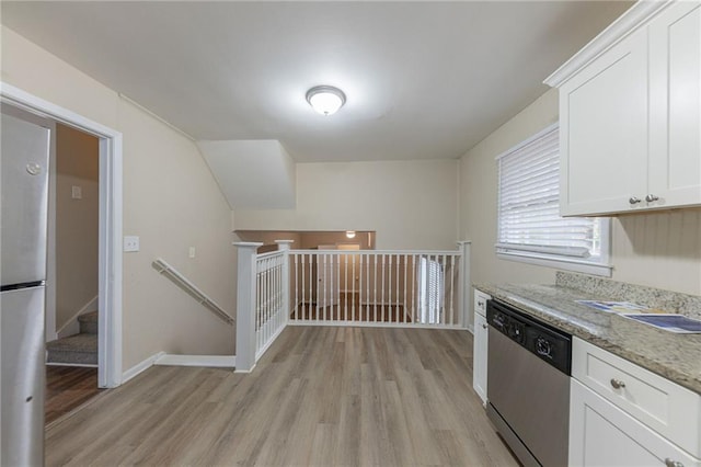 3390 Glenview Cir SW, Atlanta, GA 30331 - kitchen with appliances with stainless steel finishes, light wood-type flooring, white cabinetry, and light stone counters