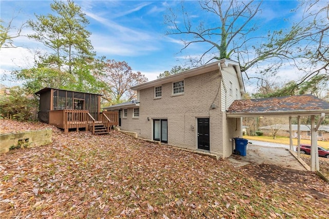 3390 Glenview Cir SW, Atlanta, GA 30331 - rear view of house with a sunroom, brick siding, a carport, and a wooden deck