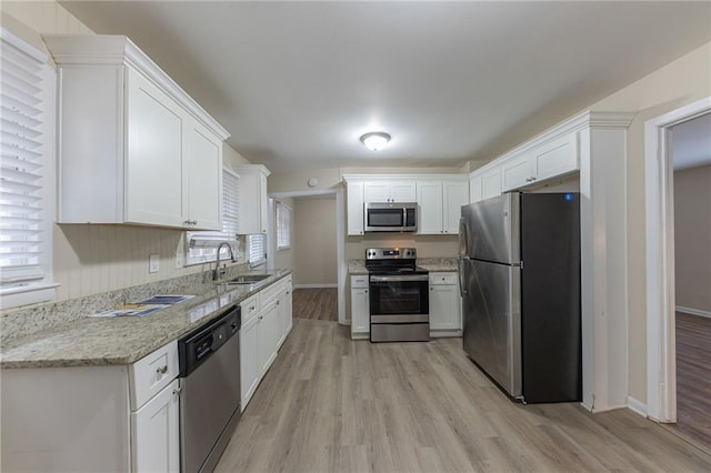 3390 Glenview Cir SW, Atlanta, GA 30331 - kitchen with stainless steel appliances, light wood finished floors, white cabinets, and light stone countertops