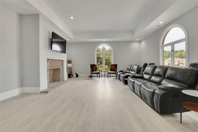 living room featuring light wood-type flooring and a healthy amount of sunlight