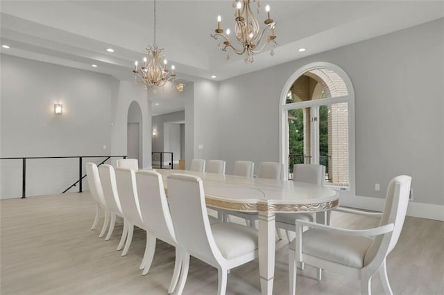 dining room featuring light hardwood / wood-style flooring and an inviting chandelier