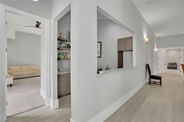 hallway with light hardwood / wood-style flooring