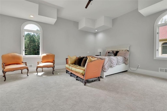 bedroom featuring carpet flooring, ceiling fan, and multiple windows