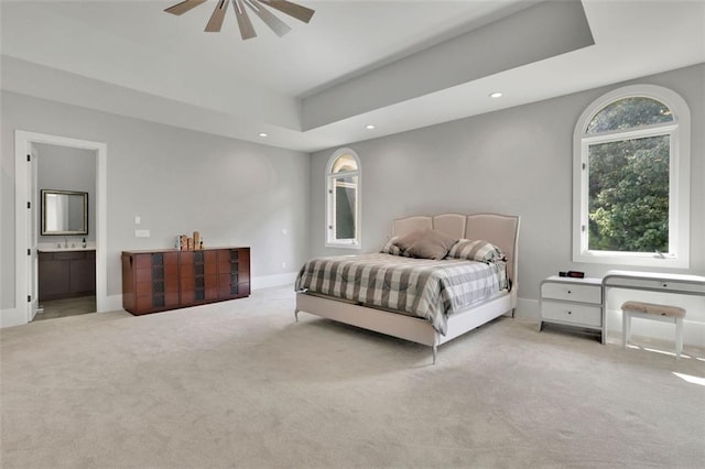 carpeted bedroom featuring ensuite bath and ceiling fan