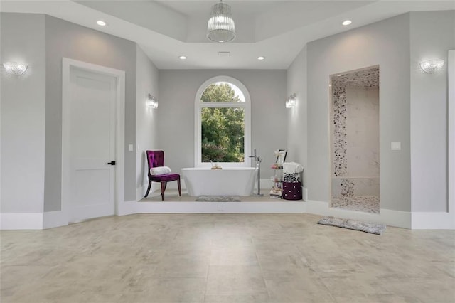 bathroom featuring plus walk in shower and a chandelier