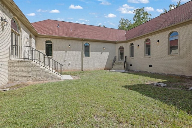 back of property featuring a lawn