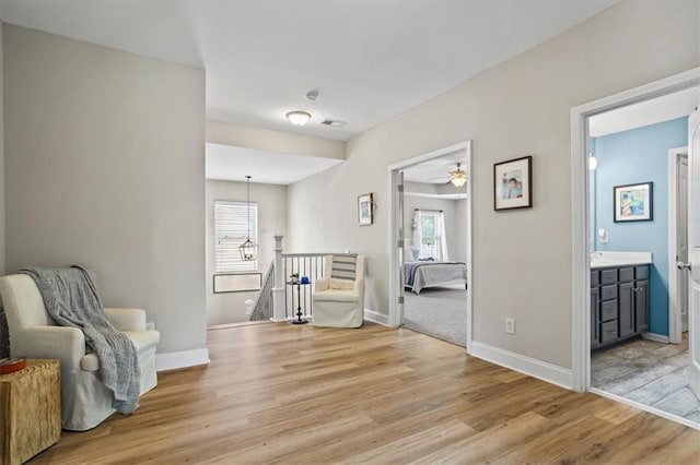 4275 Hunters Walk Way, Cumming, GA 30028 - sitting room with an upstairs landing, light wood-style floors, and ceiling fan