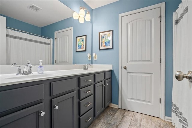 4275 Hunters Walk Way, Cumming, GA 30028 - bathroom featuring double vanity and wood finished floors