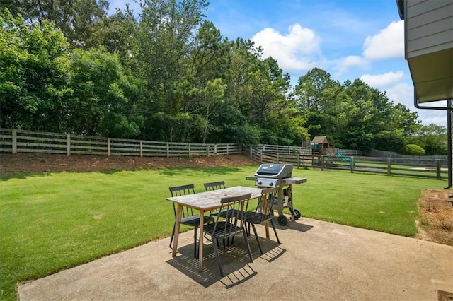 4275 Hunters Walk Way, Cumming, GA 30028 - fenced backyard with a patio area, outdoor dining area, a playground, area for grilling, and view of scattered trees