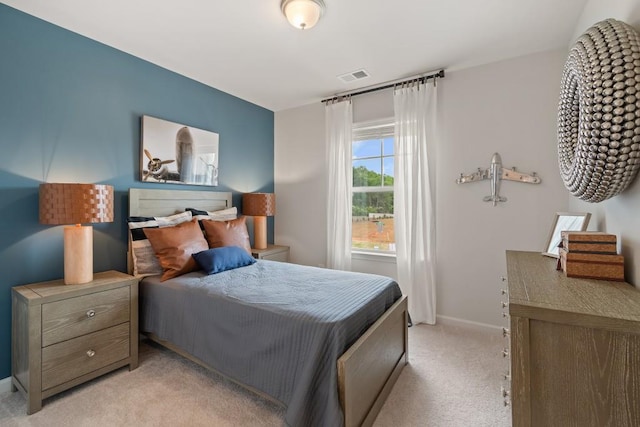 bedroom with light carpet and baseboards
