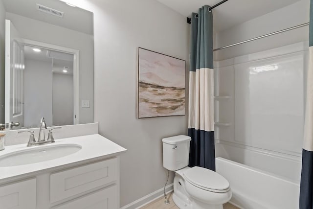 bathroom featuring toilet, baseboards, vanity, and shower / bath combo with shower curtain