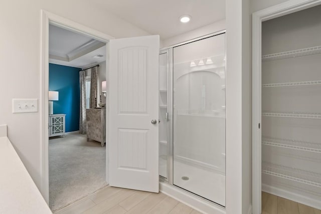 full bath with a stall shower, a walk in closet, and recessed lighting