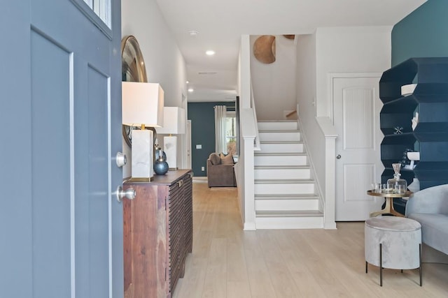 entrance foyer with light wood-style flooring, stairway, and recessed lighting