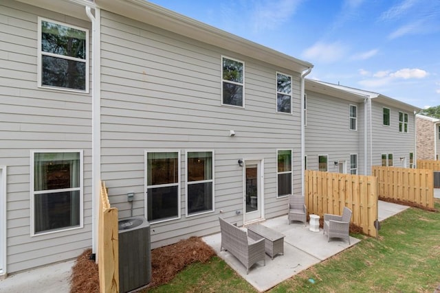 back of house with central AC unit, fence, and a patio