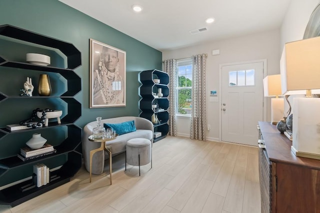 living area featuring wood finished floors, recessed lighting, and baseboards