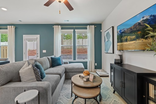 living area featuring plenty of natural light, light wood-style flooring, and ceiling fan
