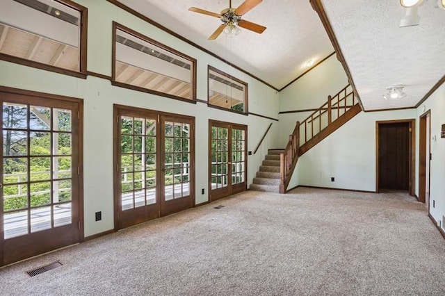 unfurnished living room featuring french doors, plenty of natural light, and carpet flooring