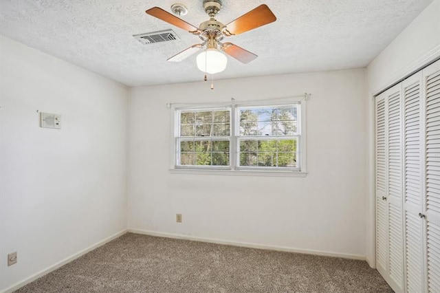 unfurnished bedroom with ceiling fan, carpet, and a closet