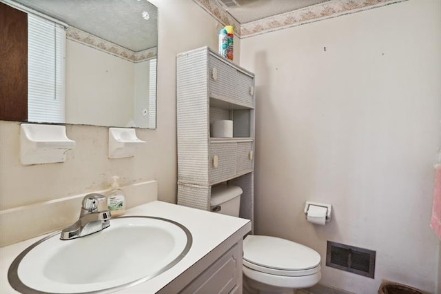 bathroom featuring toilet and vanity