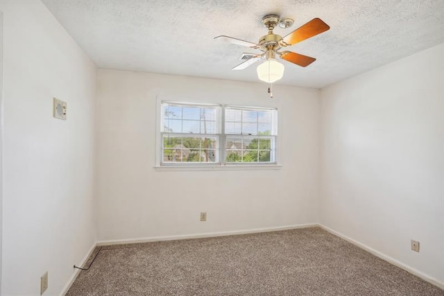 unfurnished room with ceiling fan, a textured ceiling, and carpet flooring