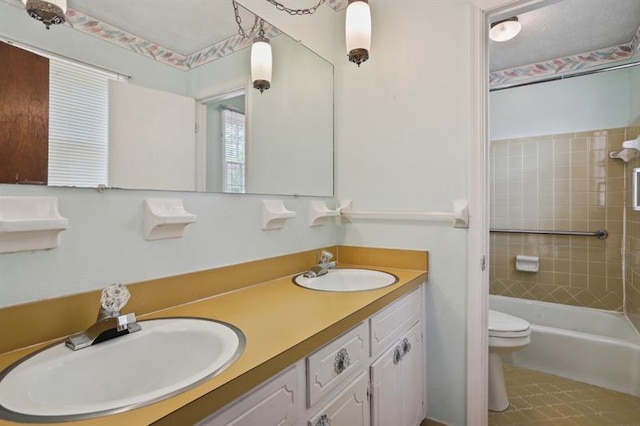 full bathroom with toilet, tiled shower / bath combo, and vanity