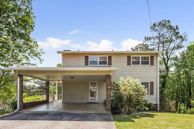 view of front of home with a front yard and a carport