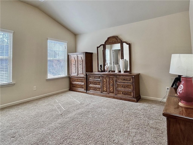 bedroom with lofted ceiling, carpet flooring, and baseboards