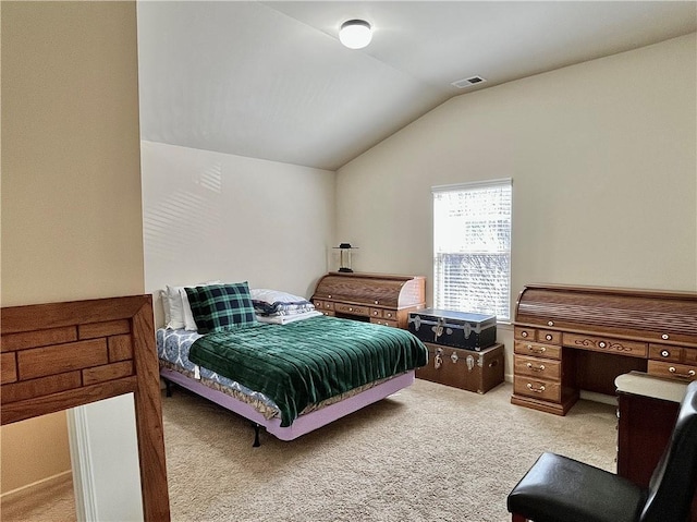 carpeted bedroom with visible vents and vaulted ceiling