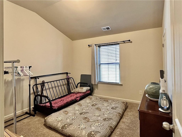 carpeted bedroom featuring lofted ceiling, visible vents, and baseboards