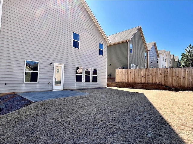 rear view of house featuring a residential view, a patio area, and fence