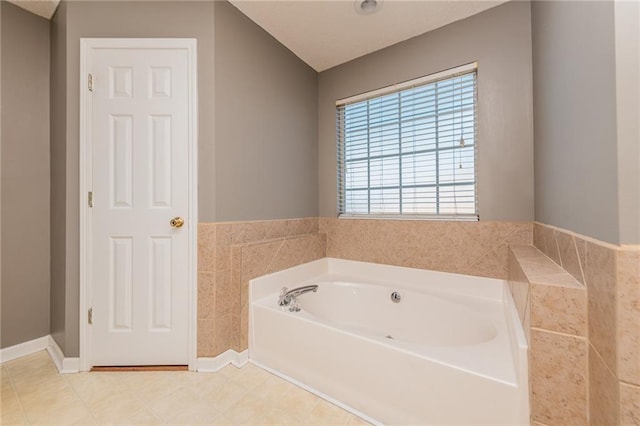 full bathroom with baseboards and a bath