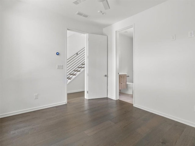 unfurnished room featuring ceiling fan and dark wood-type flooring