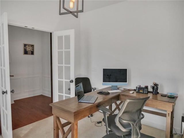 home office with light hardwood / wood-style floors and french doors