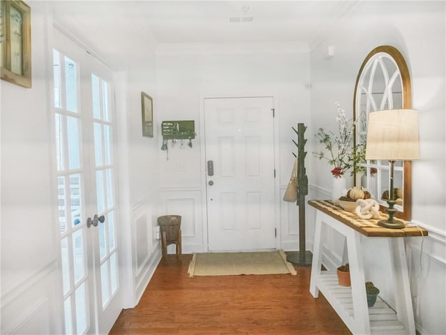 foyer entrance featuring crown molding, french doors, and hardwood / wood-style flooring