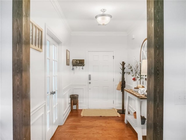 doorway featuring crown molding and wood-type flooring