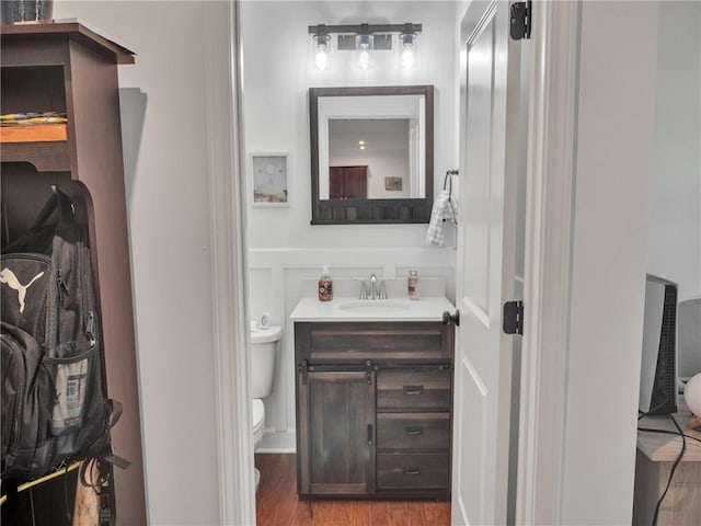 bathroom featuring vanity, hardwood / wood-style floors, and toilet